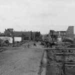 This is a scene of the Great Fire of Ellensburg, looking north on Pearl Street from 2nd Avenue. The undamaged building with the onion-shaped finials is the Lynch Block (also known as the 1888 Building), which was one of five downtown buildings that survived the fire and which is the only one still standing. (Kittitas County Historical Museum)